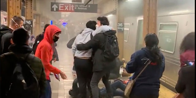 This photo provided by Will B Wylde, a person is aided outside a subway car in the Brooklyn borough of New York, Tuesday, April 12, 2022.