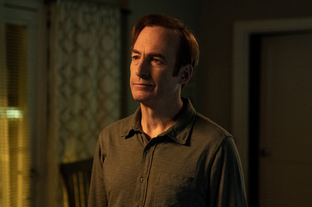 Bob Odenkirk as Jimmy McGill/Saul Goodman in the final season of "Better Call Saul." He's wearing a brown button-down shirt and looking off-camera with a very slight smirk on his face.