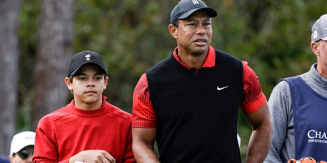 Tiger Woods, right, and his son Charlie Woods, left, prepare to tee off on the 3rd hole during the final round of the PNC Championship golf tournament Sunday, Dec. 18, 2022, in Orlando, Florida.