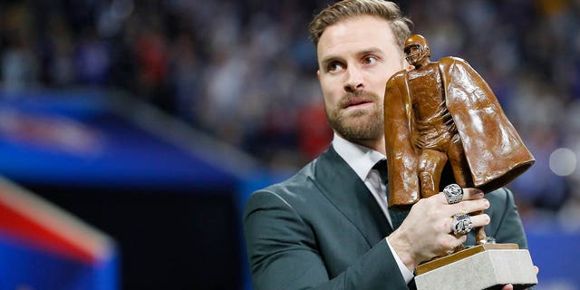 Chris Long holds the Walter Payton Award during Super Bowl LIII at Mercedes-Benz Stadium Feb. 3, 2019, in Atlanta.