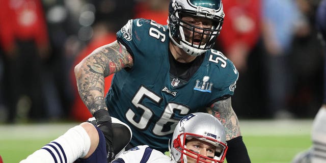 Tom Brady (12) of the New England Patriots is tackled by Chris Long (56) of the Philadelphia Eagles in the fourth quarter in Super Bowl LII at U.S. Bank Stadium Feb. 4, 2018, in Minneapolis.