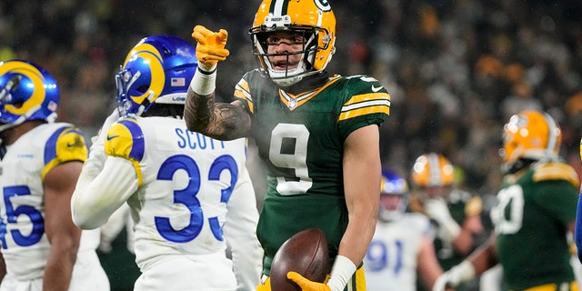 Packers wide receiver Christian Watson signals for a first down against the Los Angeles Rams in Green Bay, Wisconsin, Monday, Dec. 19, 2022.