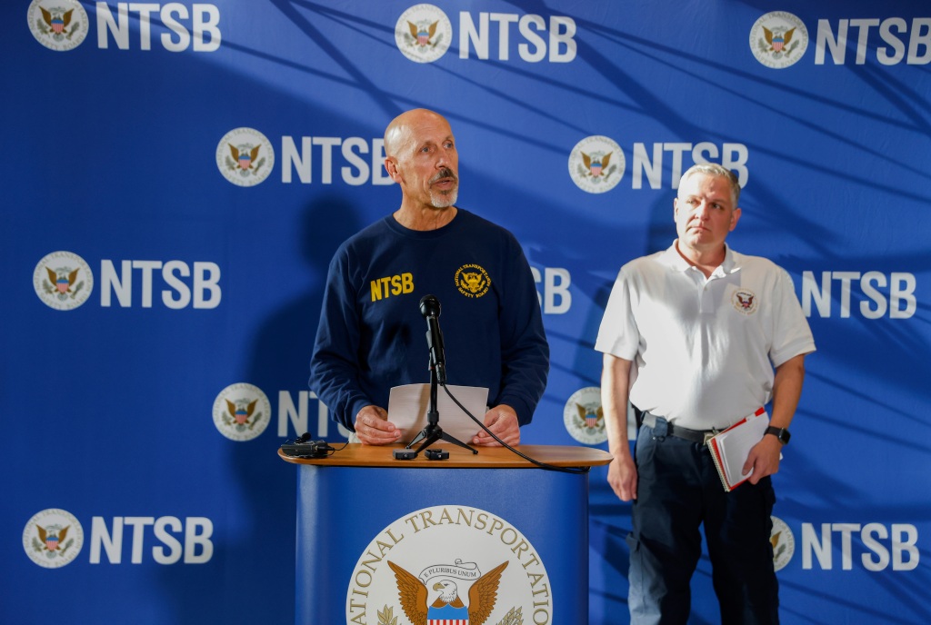 National Transportation Safety Board member Michael Graham, left, speaks to the press at the Dallas Executive Airport Terminal on Nov. 13, 2022, in Dallas.