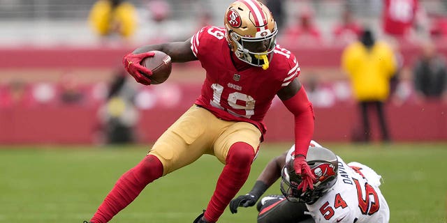 San Francisco 49ers wide receiver Deebo Samuel (19) runs in front of Tampa Bay Buccaneers linebacker Lavonte David (54) during the first half of an NFL football game in Santa Clara, Calif., Sunday, Dec. 11, 2022. 