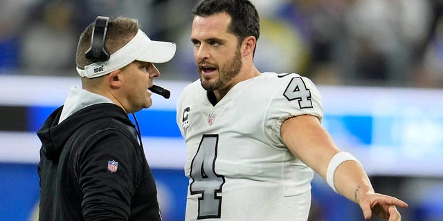 Las Vegas Raiders head coach Josh McDaniels, left, talks with quarterback Derek Carr during the second half of an NFL football game against the Los Angeles Rams, Thursday, Dec. 8, 2022, in Inglewood, California.