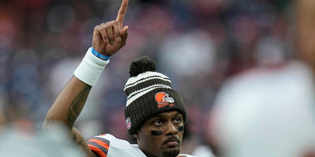 Cleveland Browns quarterback Deshaun Watson signals to fans before the game against the Houston Texans in Houston on Dec. 4, 2022.