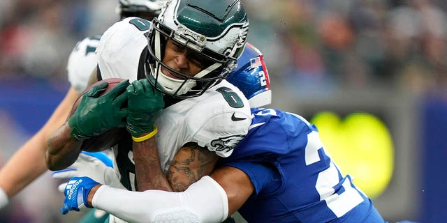 Philadelphia Eagles wide receiver DeVonta Smith (6) breaks a tackle by New York Giants safety Julian Love (20) as he comes down with a pass on his way to score a touchdown during the second quarter, Sunday, Dec. 11, 2022, in East Rutherford, New Jersey.