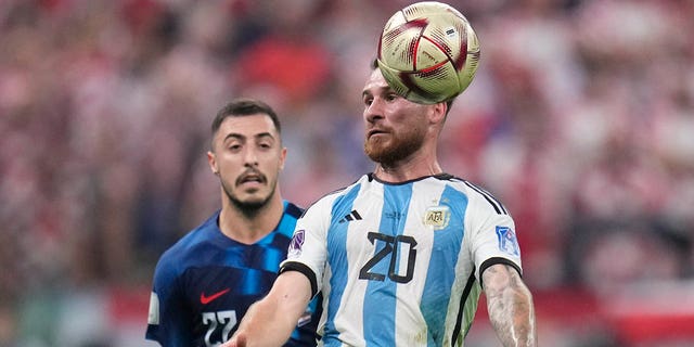 Argentina's Enzo Fernandez, front., and Croatia's Josip Juranovic fight for possession during the World Cup semifinal soccer match between Argentina and Croatia at the Lusail Stadium in Lusail, Qatar, Tuesday, Dec. 13, 2022.