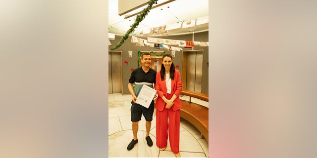 New Zealand Prime Minister Jacinda Ardern and ACT Party Leader David Seymour sign a copy of the Hansard transcript.