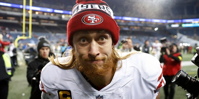 George Kittle #85 of the San Francisco 49ers runs off the field after defeating the Seattle Seahawks at Lumen Field on December 15, 2022 in Seattle, Washington.