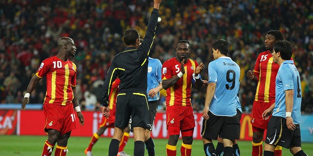 Luis Suarez of Uruguay is sent off by Referee Olegario Benquerenca after handling the ball on the goal line during the 2010 FIFA World Cup South Africa Quarter Final match between Uruguay and Ghana at the Soccer City stadium on July 2, 2010, in Johannesburg, South Africa. 