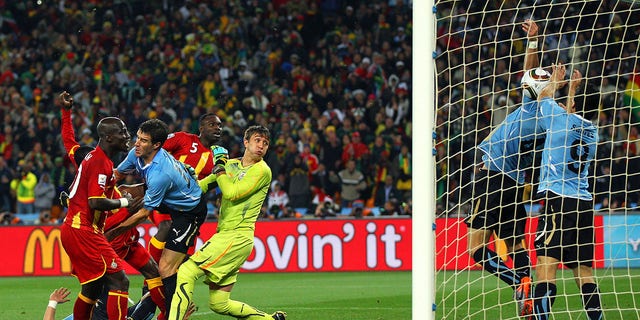 Luis Suarez of Uruguay handles the ball on the goal line, for which he is sent off, during the 2010 FIFA World Cup South Africa Quarter Final match between Uruguay and Ghana at the Soccer City stadium on July 2, 2010, in Johannesburg, South Africa.  