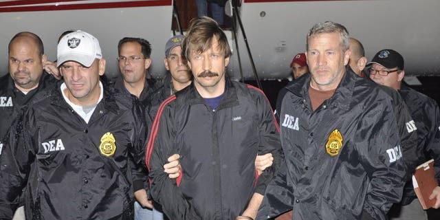 Former Soviet military officer and arms trafficking suspect Viktor Bout, center, deplanes after arriving at Westchester County Airport Nov. 16, 2010 in White Plains, New York.