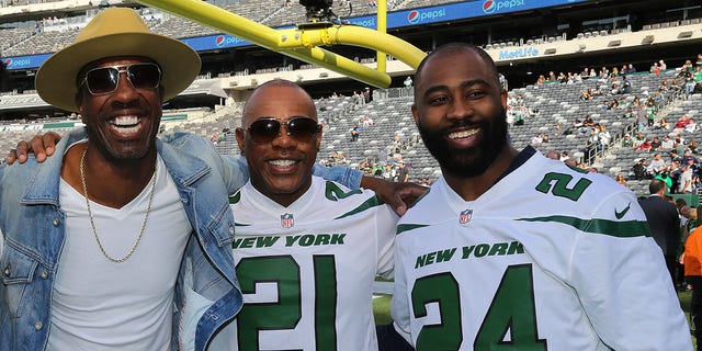 (L-R) Actor J.B. Smoove meets with New York Jets All-Time Team members Victor Green (21) and Darrelle Revis (24) when he attends a Dallas Cowboys-New York Jets game at MetLife Stadium Oct. 13, 2019, in East Rutherford, N.J. 