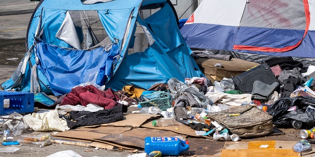 Los Angeles, CA - March 17: Tents and belongings at a homeless encampment in Toriumi Plaza at 1st St and Judge John Aiso St in Los Angeles Thursday, March 17, 2022.  The encampment has been fenced off and people living there have been asked to leave. The plaza is being closed for maintenance and repairs according to officials. The Los Angeles Homeless Services Authority is providing shelter and services for those displaced by the closure.  