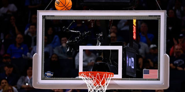 The game ball gets stuck on the backboard in the NCAA Men's Basketball Tournament in 2022. 