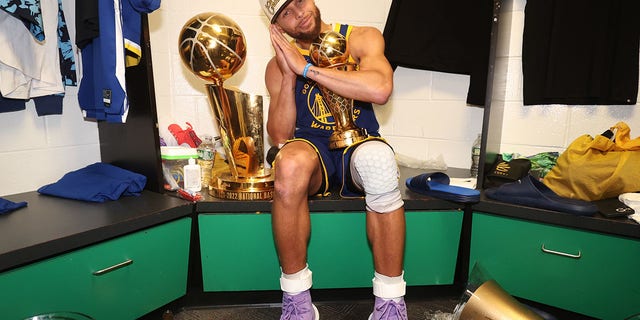 Stephen Curry of the Golden State Warriors celebrates with the Bill Russell NBA Finals MVP Award after game 6 of the NBA Finals at TD Garden in Boston on June 16, 2022.