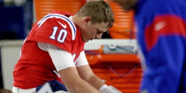 Mac Jones of the New England Patriots sits on the bench after losing 24-10 against the Buffalo Bills at Gillette Stadium Dec. 1, 2022, in Foxboro, Mass. 