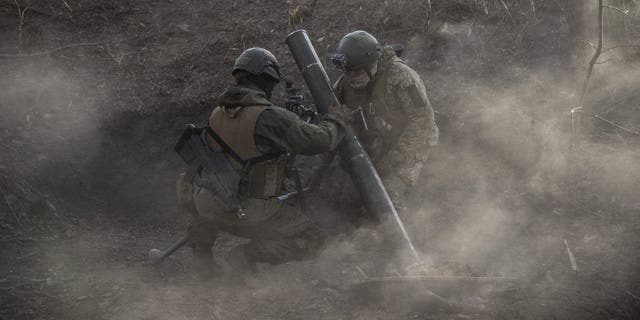 Ukrainian servicemen are seen after they fired a mortar load in the Toretsk frontline in Donbas, Ukraine, Dec. 2, 2022. 