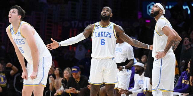 The Lakers' Austin Reaves (15), LeBron James (6) and Anthony Davis (3) react to a foul call during fourth period action at Crypto.com Arena Nov. 8, 2022. 