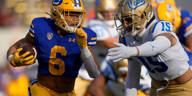 Jaydn Ott of the California Golden Bears rushes with the ball against the UCLA Bruins at California Memorial Stadium on Nov. 25, 2022, in Berkeley.