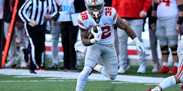 TreVeyon Henderson (32) of the Ohio State Buckeyes runs in for a touchdown after making a catch in the first quarter against the Maryland Terrapins at SECU Stadium Nov. 19, 2022, in College Park, Md. 