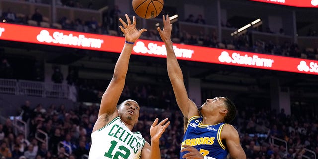 Grant Williams of the Boston Celtics shoots over Jordan Poole of the Golden State Warriors at Chase Center on Dec. 10, 2022, in San Francisco, California.