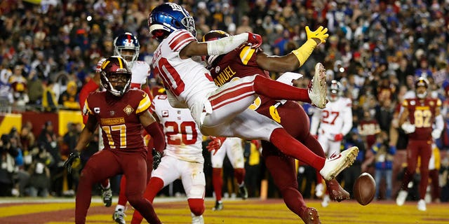 Darnay Holmes, #30 of the New York Giants, breaks up a pass intended for Curtis Samuel, #10 of the Washington Commanders, during the fourth quarter at FedExField on Dec. 18, 2022 in Landover, Maryland. 