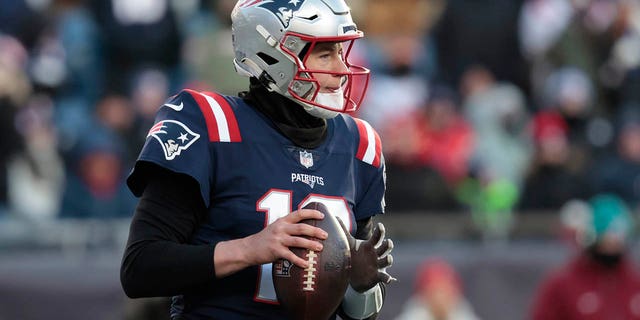 Mac Jones, #10 of the New England Patriots, looks down field during the second half against the Cincinnati Bengals at Gillette Stadium on December 24, 2022, in Foxborough, Massachusetts.