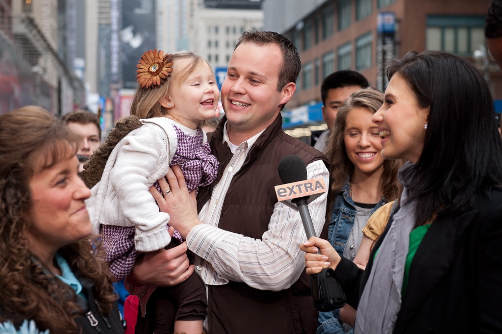 Josh Duggar holds his daughter during their visit with "Extra" in Times Square on March 11, 2013.