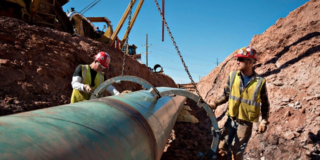 Workers are pictured near a Keystone XL pipeline project site in 2013.