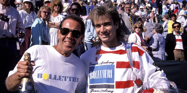 Tournament of Champions, Closeup of Andre Agassi (R) and Nick Bollettieri (L) victorious with champagne after match, New York, NY 1/1/1988--12/31/1988.