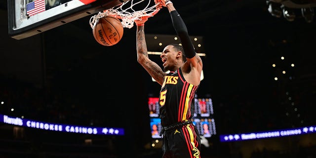 ATLANTA, GA - DECEMBER 5: Dejounte Murray, #5 of the Atlanta Hawks, slam dunks during the game against the Oklahoma City Thunder on December 5, 2022, at State Farm Arena in Atlanta, Georgia. 