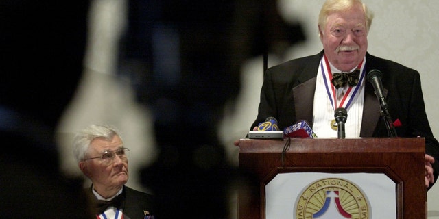 Joseph Kittinger Jr. (R), balloon pilot who broke the record flying to 102,800 feet, speaks to the media as Paule Tibbets listens during a press conference July 19, 2003, in Dayton, Ohio.