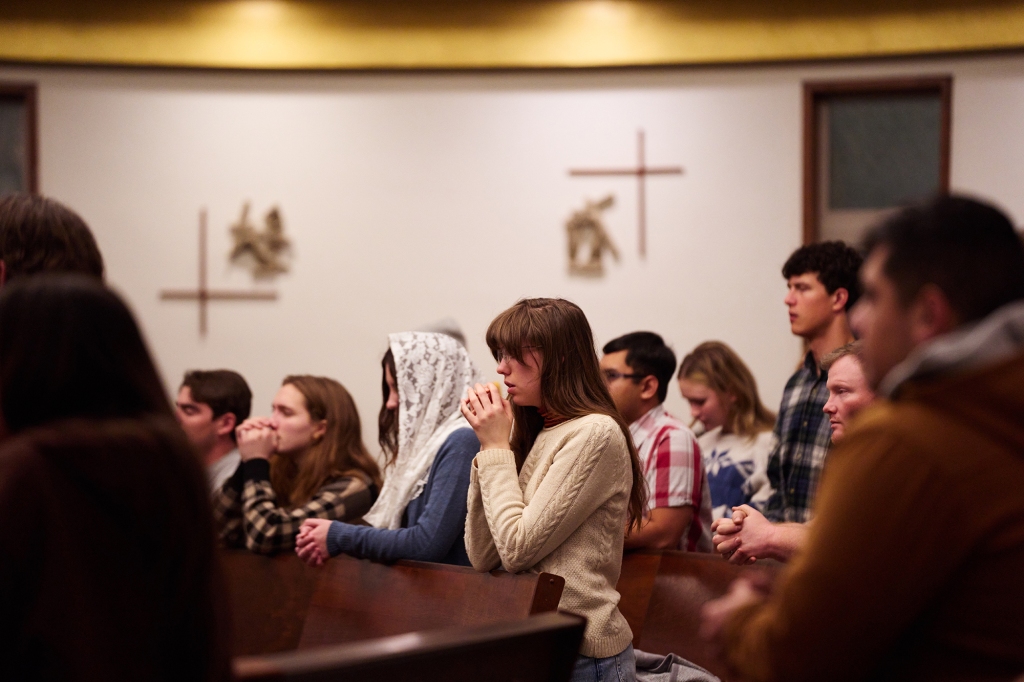 People pray for the victims at a church service in Moscow, Idaho on Dec. 4, 2022.