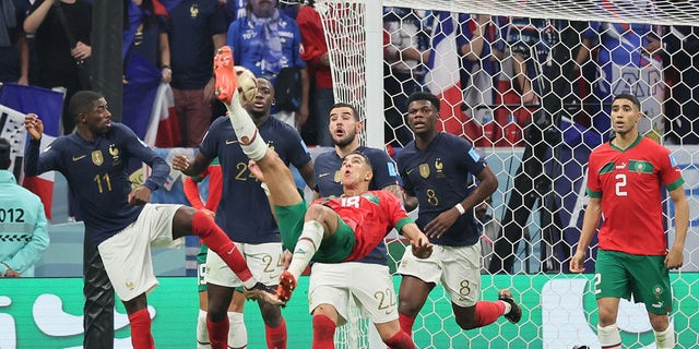 Morocco defender Jawad El Yamiq (18) attempts a shot during a Qatar 2022 World Cup semifinal match against France at Al-Bayt Stadium in Al Khor, north of Doha, Dec. 14, 2022.