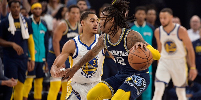 Memphis Grizzlies guard Ja Morant (12) is defended by Golden State Warriors guard Jordan Poole (3) during the first half of Game 2 of a second-round NBA playoff series May 3, 2022, in Memphis, Tenn.