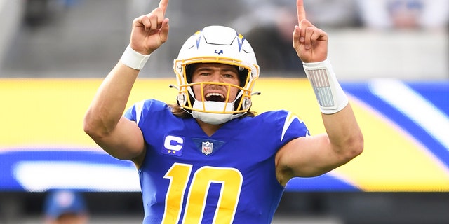 Los Angeles Chargers quarterback Justin Herbert (10) celebrates during the NFL regular season game between the Tennessee Titans and the Los Angeles Chargers on December 18, 2022, at SoFi Stadium in Inglewood, CA.