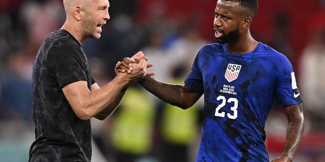 USA coach Gregg Berhalter, left, congratulates midfielder Kellyn Perry-Acosta at the end of the World Cup Group B match against Iran at Al Thumama Stadium in Doha, Qatar, on Nov. 29, 2022.