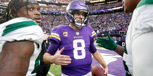 Minnesota Vikings quarterback Kirk Cousins, #8, talks with New York Jets players after an NFL football game, Sunday, Dec. 4, 2022, in Minneapolis. 