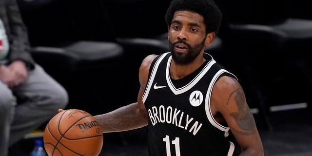 Brooklyn Nets guard Kyrie Irving handles the ball during an NBA basketball game against the Dallas Mavericks in Dallas May 6, 2021. Unable to attend the Brooklyn Nets' media day, Irving asked for privacy Monday when pressed about his vaccination status and availability for home games.