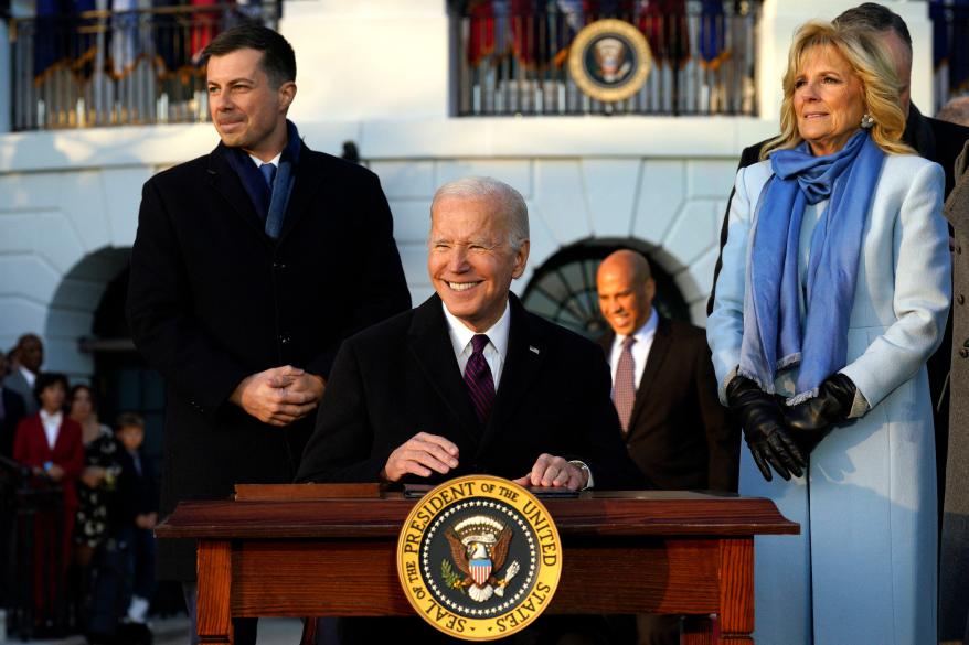 President Joe Biden signs the Respect for Marriage Act in front of the White House.