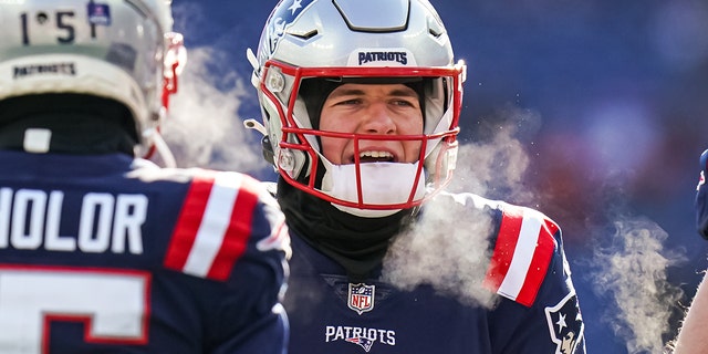 Dec 24, 2022; Foxborough, Massachusetts, USA; New England Patriots quarterback Mac Jones (10) warms up before the start of the game against the Cincinnati Bengals at Gillette Stadium. 