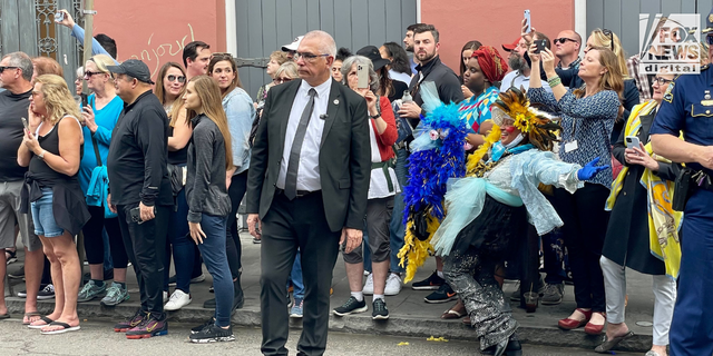 Some of the colorful crowd of well-wishers hoping to catch a glimpse of French President Emmanuel Macron during his diplomatic tour of the French Quarter in New Orleans, December 2022.