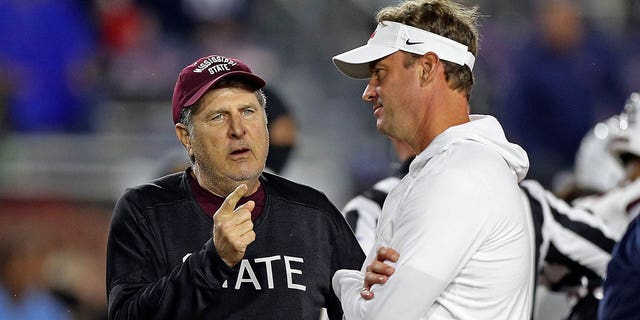 Mississippi State Bulldogs head coach Mike Leach and Mississippi Rebels head coach Lane Kiffin talk before the game at Vaught-Hemingway Stadium on Nov. 24, 2022 in Oxford, Mississippi.