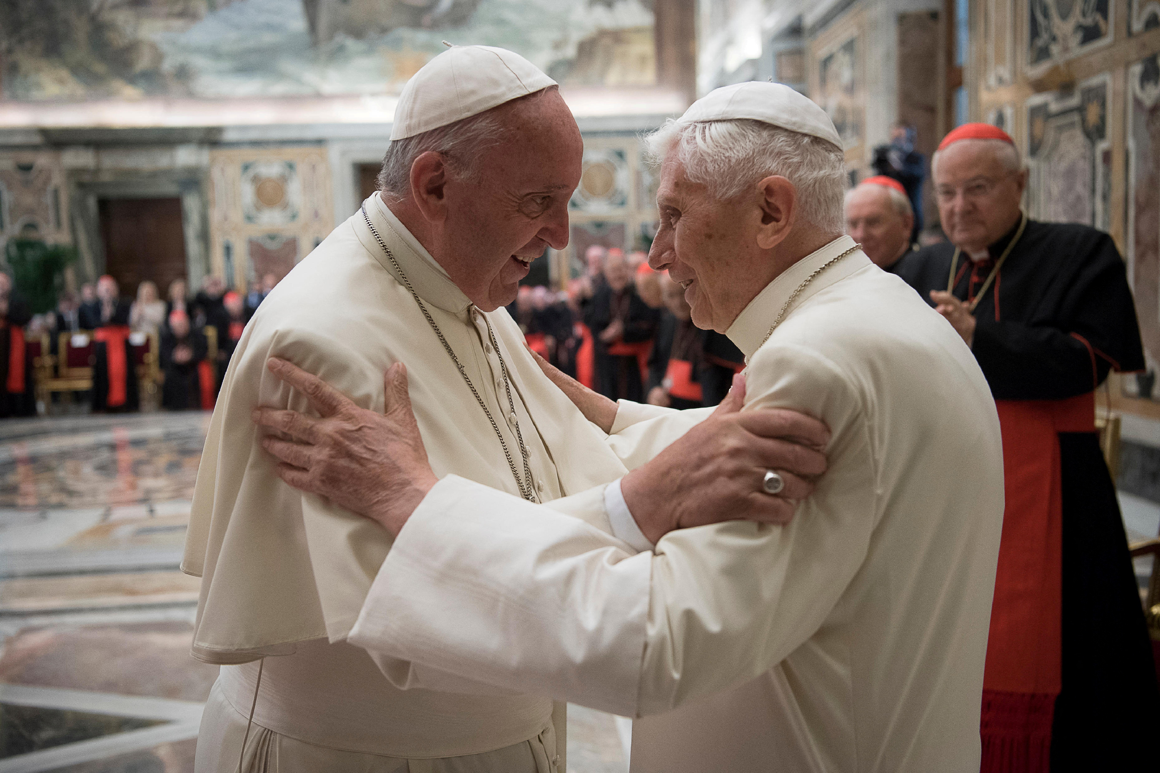 Former pope Benedict is greeted by Pope Francis during a ceremony to mark his 65th anniversary of ordination to the priesthood at the Vatican June 28, 2016.