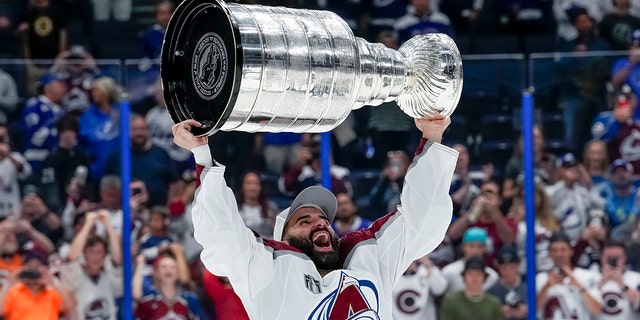 Colorado Avalanche center Nazem Kadri hoists the Stanley Cup following game 6 of the finals against the Tampa Bay Lightning at Amalie Arena in Tampa, Florida, on June 26, 2022.