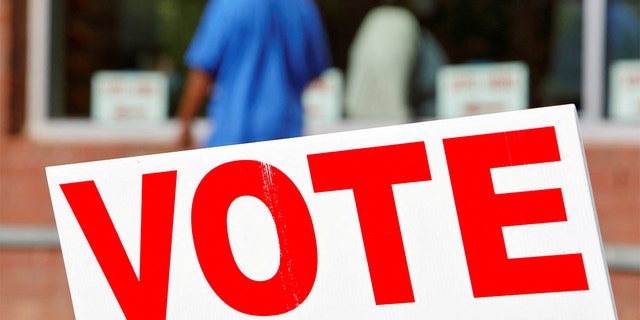 FILE PHOTO: Signs direct voters into a polling station during the 2020 presidential election in Durham, North Carolina, Nov. 3, 2020.   REUTERS/Jonathan Drake/File Photo