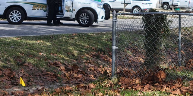 Police cruisers line up outside a Florida home where a deputy was shot and killed on Christmas Eve.