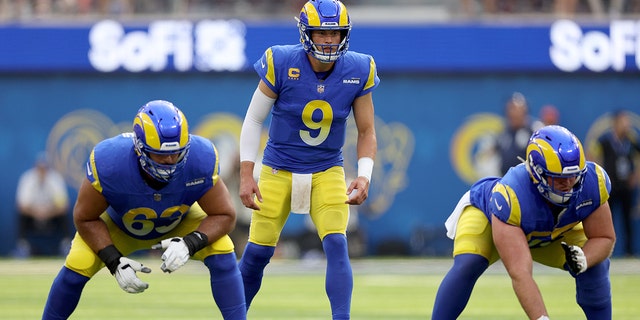 Matthew Stafford #9 of the Los Angeles Rams sets up in the shotgun behind Brian Allen #55 and Oday Aboushi #63 during a 31-14 loss to the San Francisco 49ers at SoFi Stadium on October 30, 2022 in Inglewood, California.